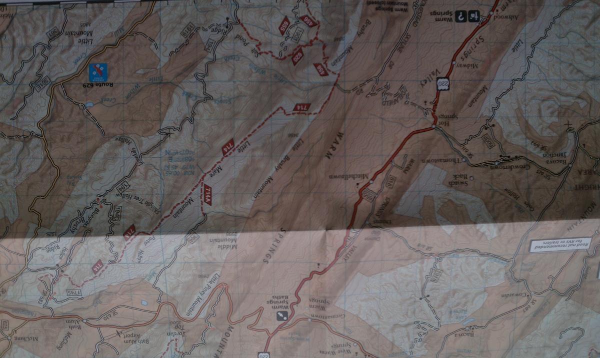 National Geographic Trails Illustrated #791 Staunton Shenandoah Mountain: A topographic map showing various routes and landmarks, with highlighted trails and points of interest in a mountainous region. Key features include road numbers, park areas, and natural landscapes. The map has some areas obscured by glare, affecting the visibility of certain details.