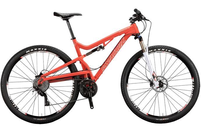 Santa Cruz Superlight: A red mountain bike with a lightweight frame, featuring front suspension, disc brakes, and Maxxis tires. The bike is positioned at an angle, showcasing its components and sleek design.