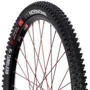 WTB Bronson 2.3: Black mountain bike tire with a tread designed for traction, featuring red sidewalls and labeled with the brand name.
