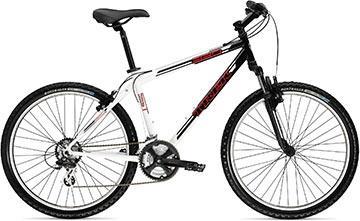 Trek 820: Mountain bike in black and white with thick tires, a curved frame, and front suspension. The bike features a prominent brand logo and a standard seat.