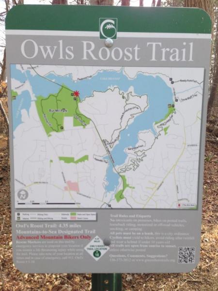 Alt text: Sign for Owls Roost Trail featuring a map indicating the trail route, which is 4.35 miles long and designated for advanced mountain bikers. The sign includes trail information and surrounding landmarks. Owls Roost (Bur-Mil Park) mountain bike trail.