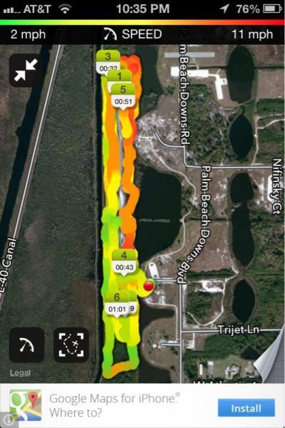 Map interface showing speed tracking data. The display includes a colorful heatmap along a canal, with numerical markers indicating time and speed at various segments. The map also features several road names, a zoom control, and a prompt to install Google Maps for iPhone at the bottom. West Delray Regional Park mountain bike trail.