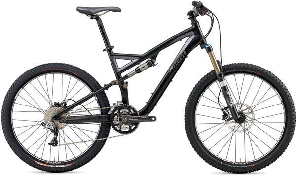 Specialized Stumpjumper FSR: A black mountain bike with a lightweight frame, featuring front and rear suspension, disc brakes, and knobby tires, positioned on a white background.