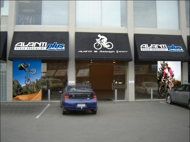 Image of a bicycle shop exterior featuring the "Alanti Plus" and "Alanti & Raleigh Scott" logos on awnings. Two images of cyclists are displayed on either side of the entrance: one showing a cyclist performing a stunt in mid-air and the other depicting a cyclist riding on a road. A parked car is visible in front of the shop.