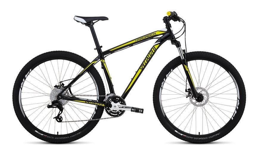 Specialized Hardrock Disc 29: A black and yellow mountain bike with a lightweight frame, disc brakes, and thick tires, positioned upright against a plain background.