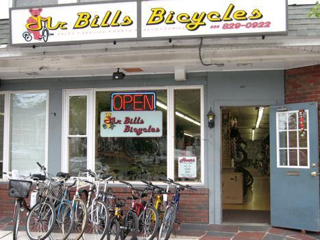 A bike shop exterior featuring a bright sign that reads "Mr. Bill