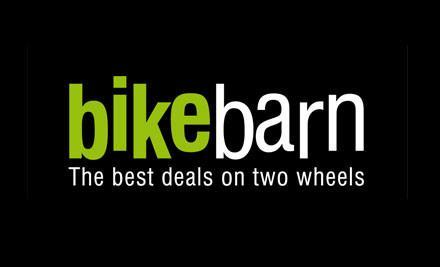 Logo for Bike Barn featuring the brand name in a bold font, with "bike" in green and "barn" in white, accompanied by the tagline "The best deals on two wheels" beneath it, all set against a black background.