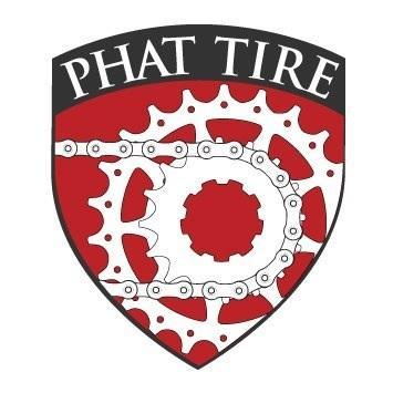 Logo for "Phat Tire," featuring a red shield design with a white gear and bicycle chain graphic. The words "PHAT TIRE" are displayed at the top in bold lettering.