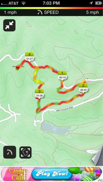 Map interface showing a winding trail with markers indicating checkpoints. The path is highlighted in red and yellow, suggesting varying speeds or progress. Timers at each checkpoint display elapsed times. The bottom section features a promotional ad for a game, along with an app interface layout. Brown County Park mountain bike trail.