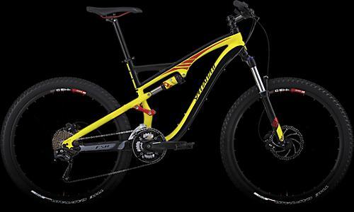 Specialized Camber: A brightly colored mountain bike with a yellow frame and black accents, featuring thick tires and a dual suspension system, set against a black background.