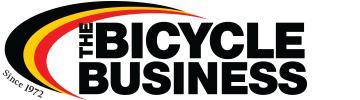 Logo of "The Bicycle Business," featuring bold text with the tagline "Since 1972" and a stylized color arc in red, yellow, and black.