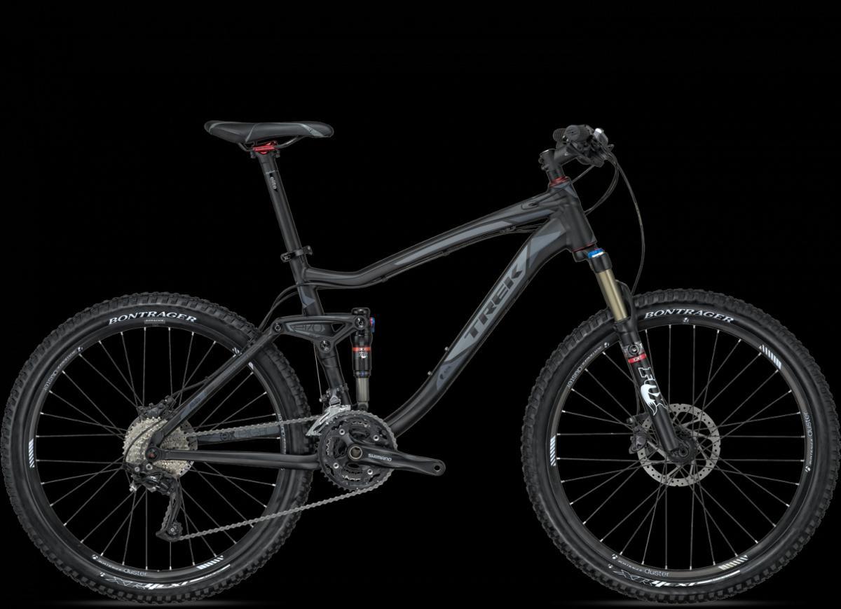Trek Fuel EX 8: Alt tag: A black Trek mountain bike with full suspension, featuring Bontrager wheels and Shimano components, displayed against a dark background.