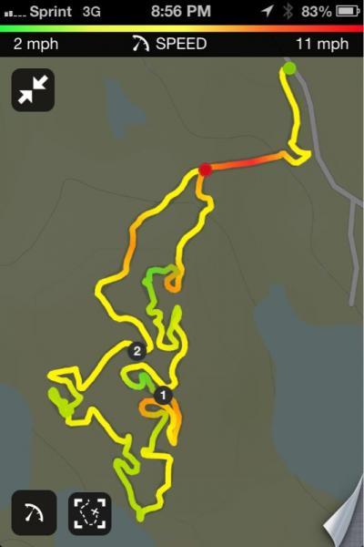 Map displaying a trail route with color-coded segments indicating speed and elevation changes. The map shows various twists and turns, with markers labeled "1" and "2" along the path. Speed readings are displayed at the top, indicating 2 mph and 11 mph in different areas. Maplelag twin lakes trail mountain bike trail.