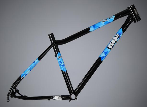 Ragley Blue Pig: A black bicycle frame with blue geometric designs displayed against a gray background. The frame is angled to show the design and structure clearly, highlighting its modern style.
