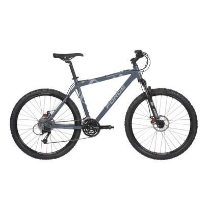 Forge Sawback 5xx: A blue-gray mountain bike with thick tires, a sturdy frame, and disc brakes. The bike is positioned upright against a neutral background, showcasing its design and features, including a gear system and handlebars.