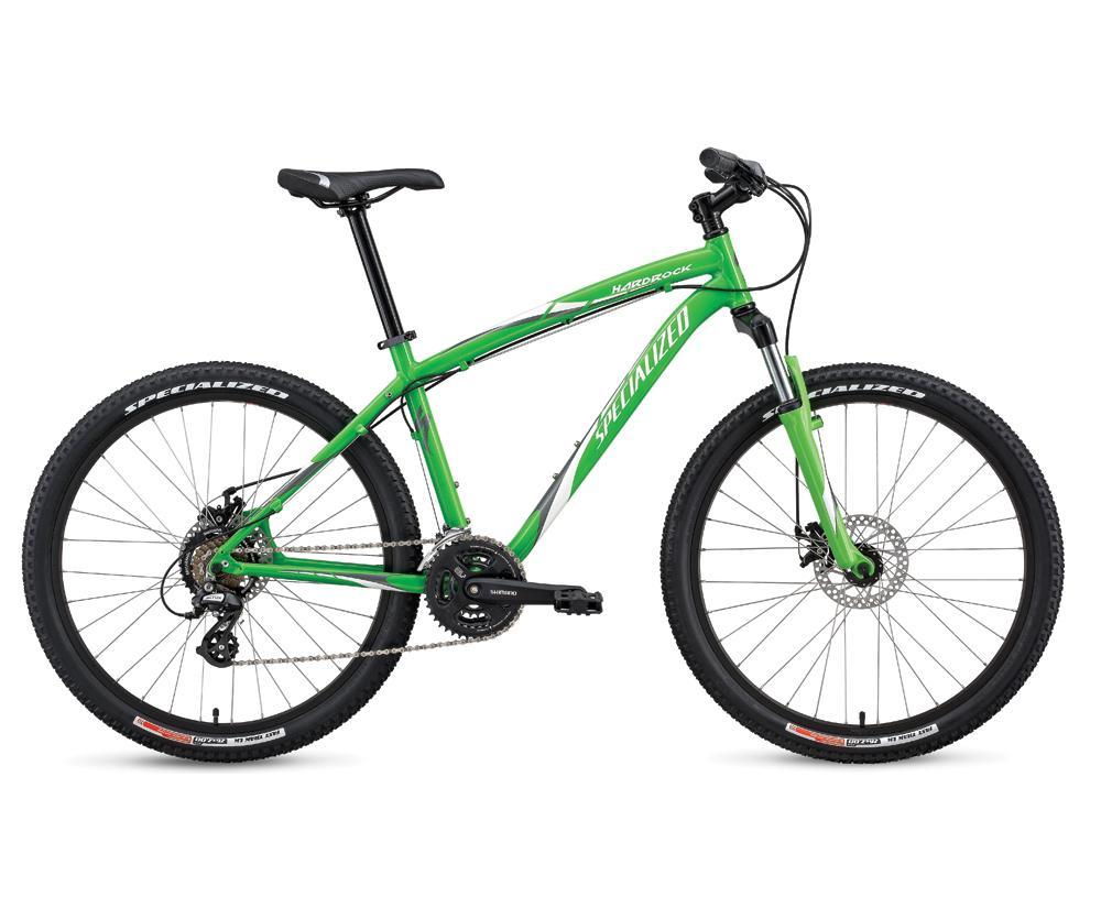Specialized Hardrock Disc: A green mountain bike with a sleek design, featuring disc brakes, a sturdy frame, and knobby tires suitable for off-road terrain. The bike is positioned sideways, showcasing its components including the handlebars, gears, and rear derailleur.