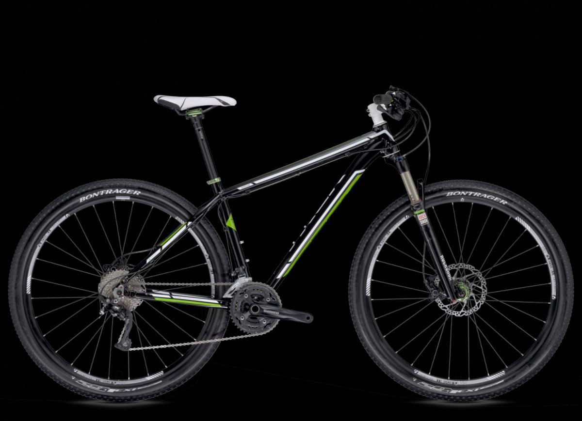 A black and green mountain bike positioned against a dark background, featuring a lightweight frame, front suspension, disc brakes, and rugged tires designed for off-road cycling.