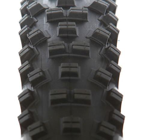 WTB Vigilante: Close-up view of a mountain bike tire tread, showcasing its knobbed design for enhanced traction and grip on various terrains.