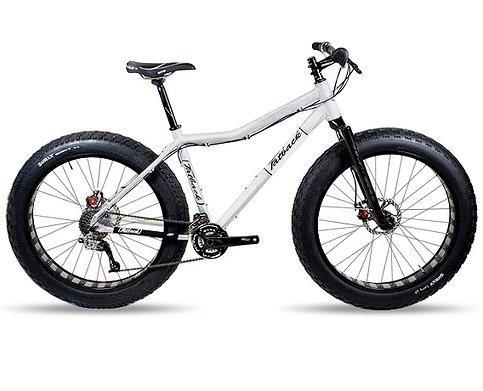 Fatback Aluminum Deluxe: A white fat bike featuring oversized tires, a sturdy frame, and front suspension, positioned on a neutral background.