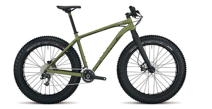 Specialized Fatboy: A sturdy fat bike with wide tires and a green frame, showcasing a streamlined design suitable for rugged terrain. The bicycle features a minimalist style with a single gear system and a front suspension fork, emphasizing durability and functionality.