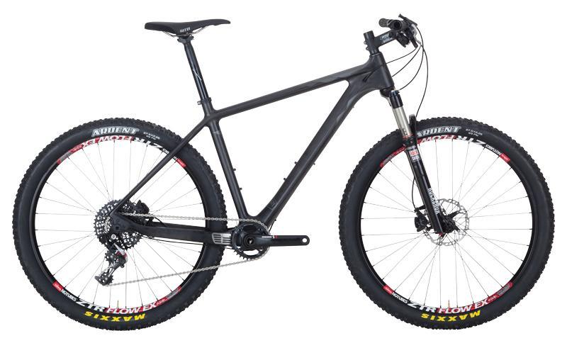 Foundry Cycles Tomahawk: A black mountain bike with a lightweight frame, featuring thick, knobby tires designed for off-road terrain. The bike has a front suspension fork, a single chainring setup, and a minimalist design, with red accents on the tires.