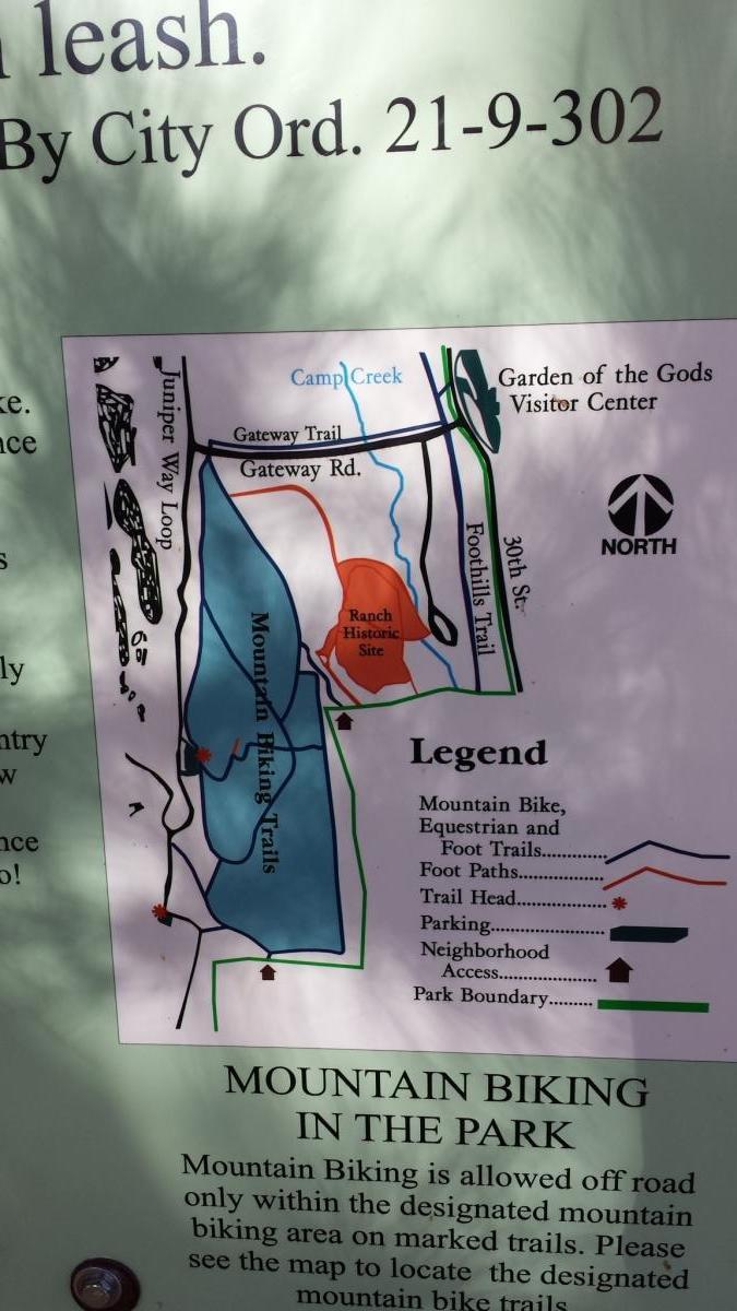 Map showing designated mountain biking trails and related features in a park, including the Garden of the Gods Visitor Center, Ranch Historic Site, trail heads, parking areas, and the park boundary. The legend illustrates different types of trails, parking locations, and access points. Garden of the Gods: Ute Trail mountain bike trail.