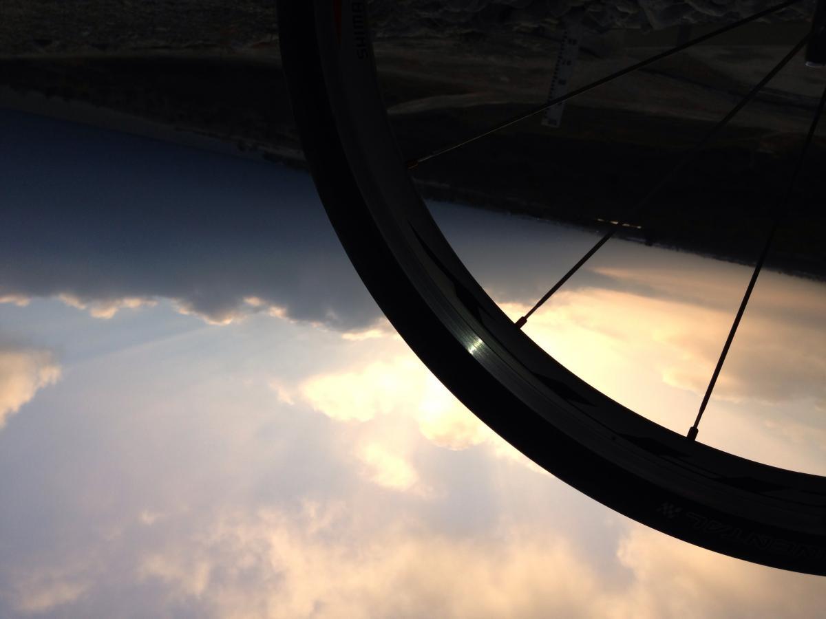 Marin Bolinas Ridge 29er: A close-up view of a bicycle wheel against a backdrop of clouds and sky, with the image rotated to show the wheel's rim and spokes prominently.