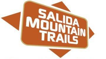 Logo for Salida Mountain Trails, featuring the text "SALIDA MOUNTAIN TRAILS" in bold white letters on a rectangular orange background, surrounded by a diamond-shaped orange design.