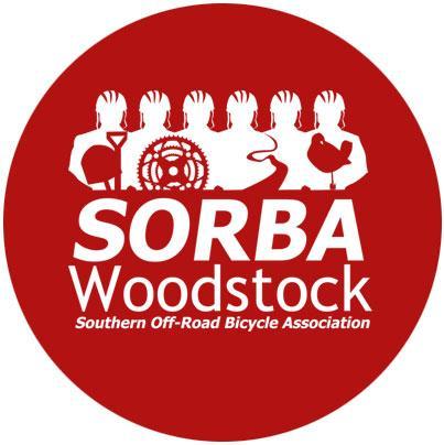 Circular logo featuring the text "SORBA Woodstock" and "Southern Off-Road Bicycle Association" in white on a red background. Silhouetted figures holding biking gear are depicted above the text.
