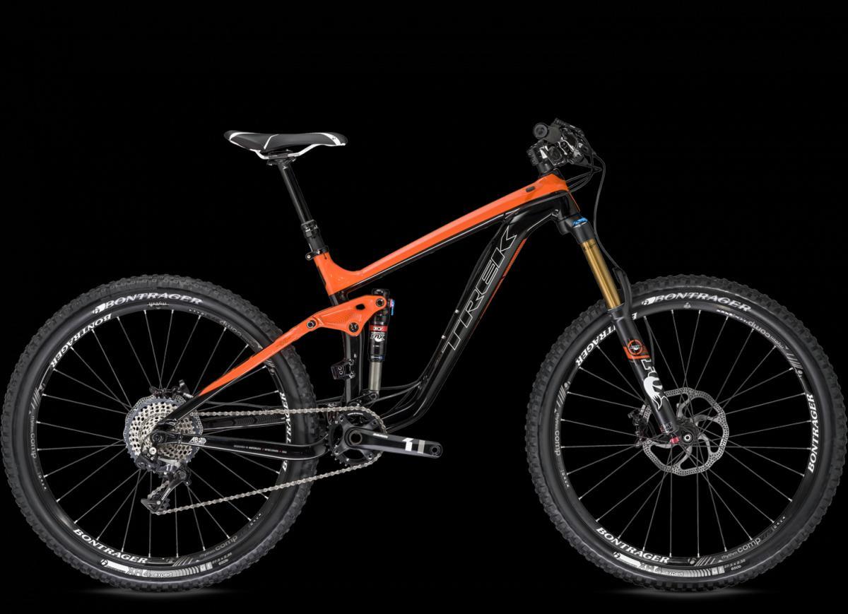 Trek Slash: A sleek mountain bike featuring a black frame with orange accents, designed for performance and durability. It has a modern suspension system, wide tires, and quality components, all set against a black background.