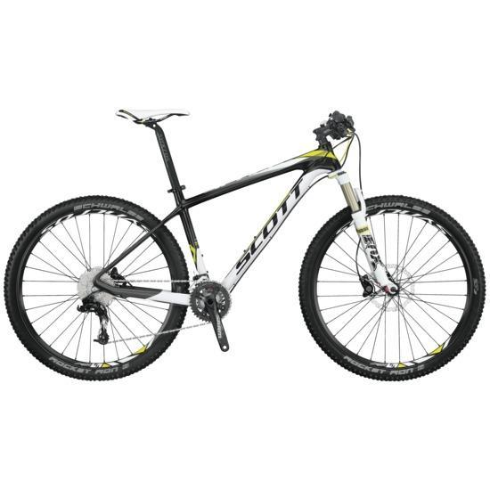 Scott Scale 730: A modern mountain bike featuring a black and white frame with yellow accents, equipped with dual suspension, thick tires, and a range of gears. The bike is positioned upright for display.
