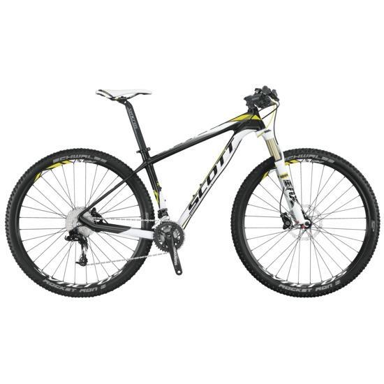 Scott Scale 930: A black and white mountain bike with yellow accents, featuring a lightweight frame, front suspension, and disc brakes. The bike is positioned sideways, showcasing its design and components.