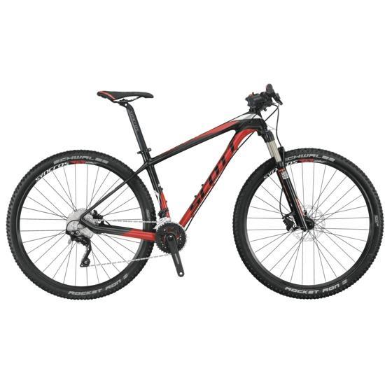 Scott Scale 935: A mountain bike with a sleek black and red design, featuring front suspension, wide tires, and a lightweight frame. The bike is positioned to show its side profile, highlighting its gearing and handlebars.