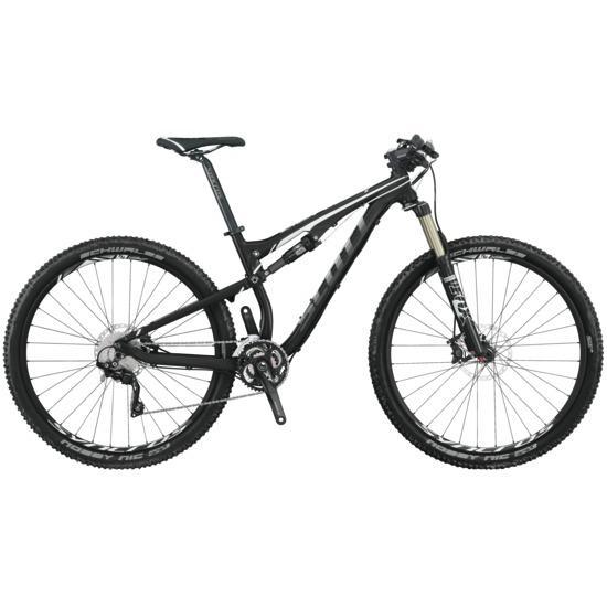 Scott Genius 930: A black and silver mountain bike with front suspension, wide tires, and a sleek design, positioned against a neutral background.