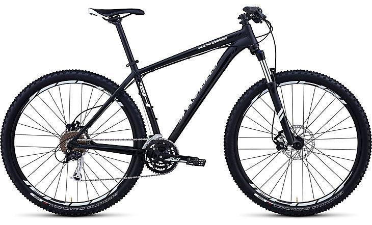 Specialized Rockhopper 29: A black mountain bike with wide tires, front suspension, and a lightweight frame, showcasing multiple gears and disc brakes.