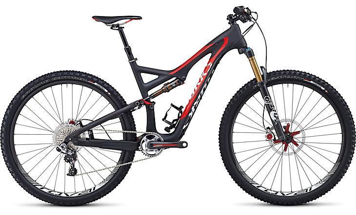 Specialized S-Works Stumpjumper FSR 29: Alt text: A high-performance mountain bike featuring a sleek design with a black and red color scheme, front suspension fork, and knobby tires, suitable for off-road trails.