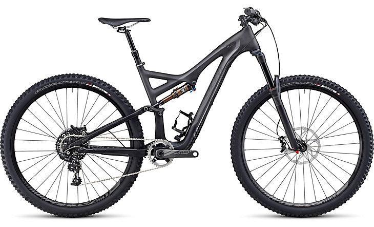 Specialized Stumpjumper FSR Expert Carbon EVO 29: A modern mountain bike with a sleek black frame, featuring front and rear suspension, wide tires, and a gear system. The bike is positioned in profile, showcasing its angular design and sturdy construction, suitable for off-road terrain.