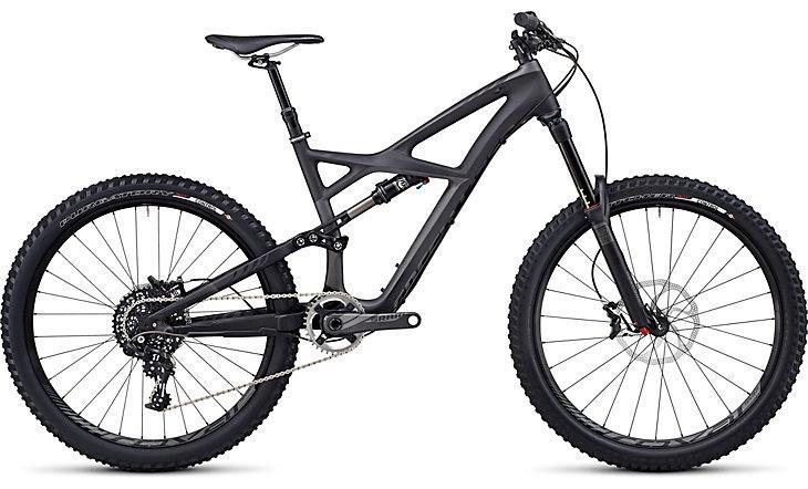 Specialized Enduro Expert Carbon: A modern mountain bike featuring a lightweight black frame, front suspension, and wide tires designed for off-road cycling. The bike includes a gear system with a chain and derailleur, showcasing a sleek and aerodynamic design suitable for various terrains.