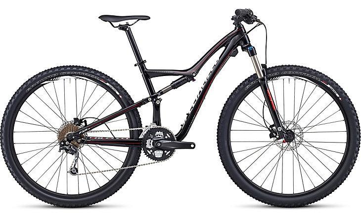 Specialized Rumor: A sleek black mountain bike featuring a full suspension design, large knobby tires, and a modern frame. The bike is equipped with a front suspension fork, disc brakes, and a multi-speed gear system, making it suitable for off-road terrain and rugged trails.