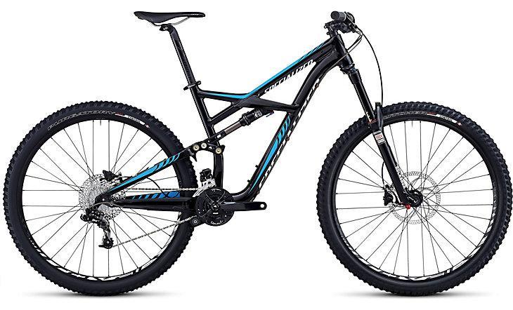 Specialized Enduro Comp 29: A black and blue mountain bike with a full suspension frame, wide tires, and disc brakes, positioned on a white background.