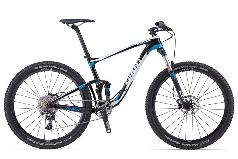 Giant Anthem Advanced 27.5 0 Team: A modern mountain bike featuring a sleek black and blue design, lightweight frame, and sturdy wheels. The bike is equipped with front suspension, a single gear shifter, and disc brakes, making it ideal for off-road cycling.