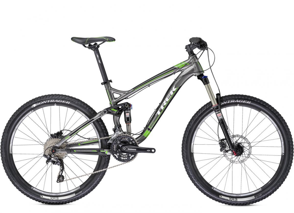 Trek Fuel EX 6 26: A sleek gray mountain bike with green accents, featuring a lightweight aluminum frame, wide tires, front suspension fork, and gear components.