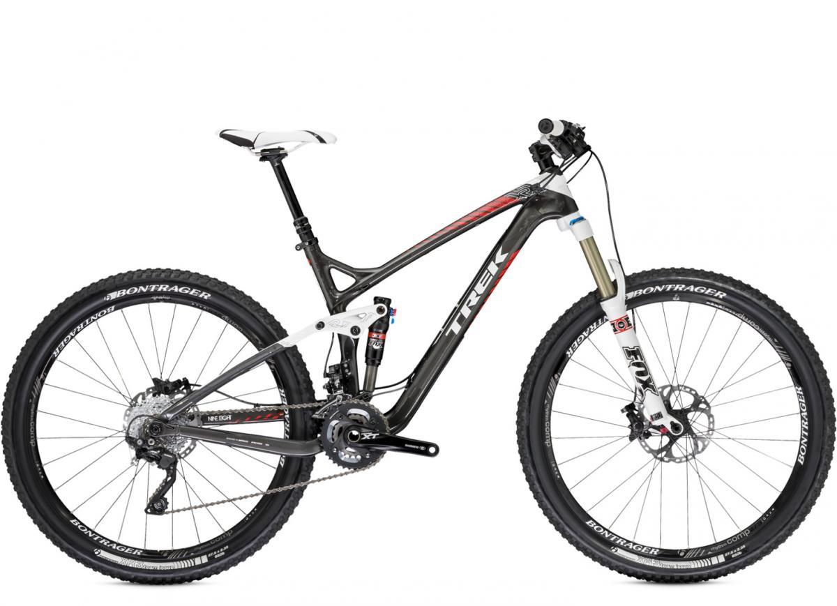 Trek Remedy 9.8 27.5/650b: Alt text: A Trek mountain bike with a sleek, modern design featuring a carbon frame, wide tires, and disc brakes. The bike is shown in a side view, highlighting its suspension system and drivetrain components.