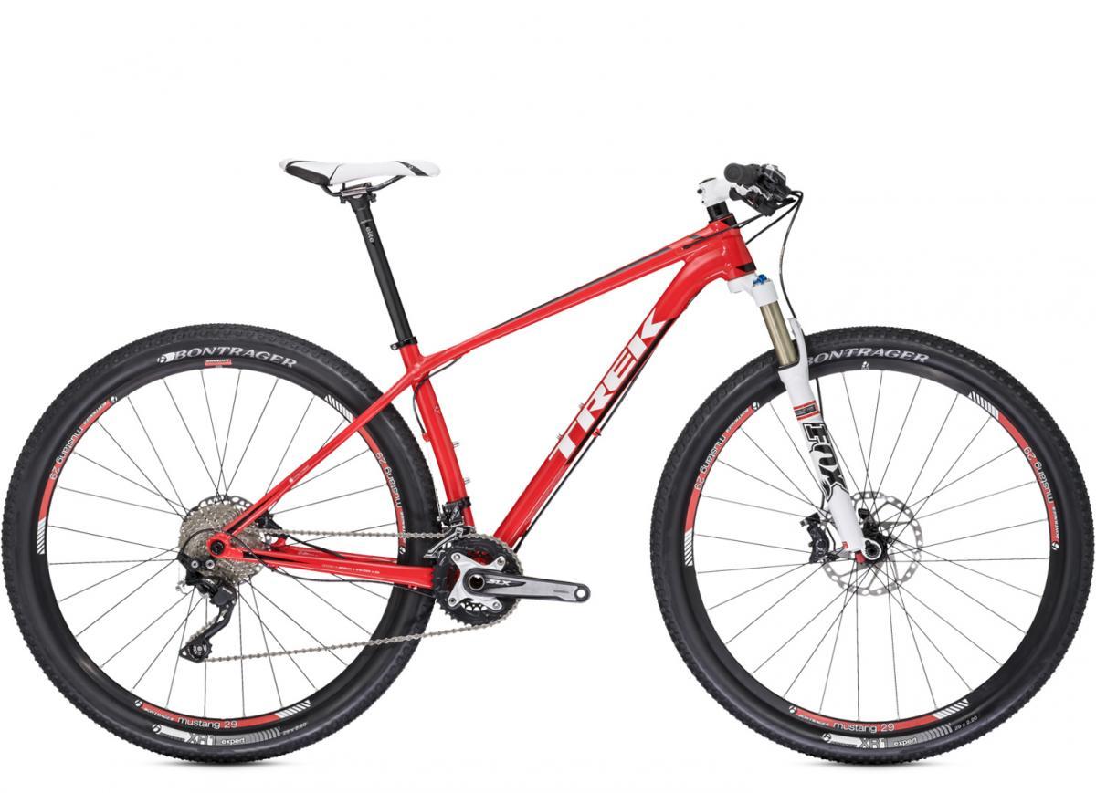 Trek Superfly 8: Alt text: A red Trek mountain bike featuring a lightweight frame, front suspension fork, and disc brakes, with Bontrager tires and a Shimano drivetrain. The bike is positioned at an angle to showcase its design.