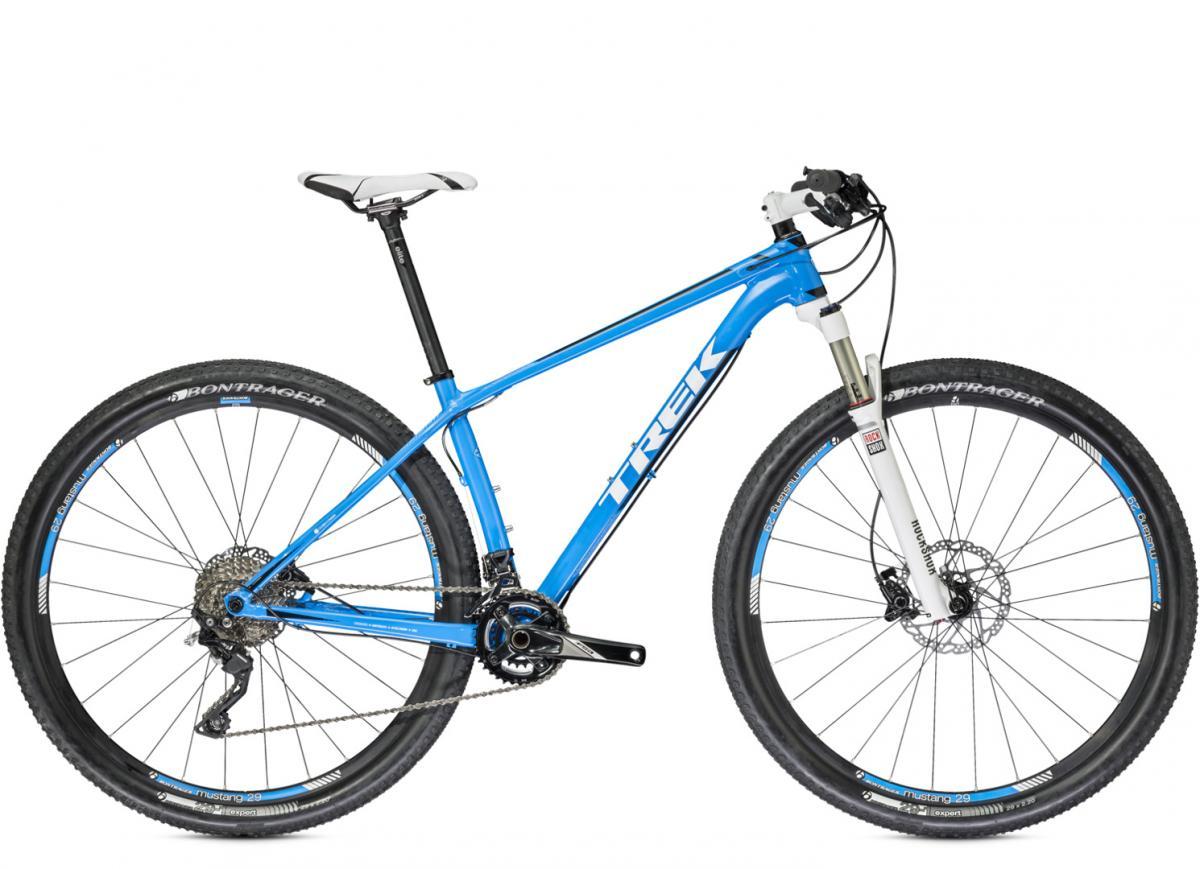 Trek Superfly 7: A blue mountain bike with a lightweight frame, front suspension, and disc brakes, featuring Bontrager tires and a sleek design, positioned against a white background.