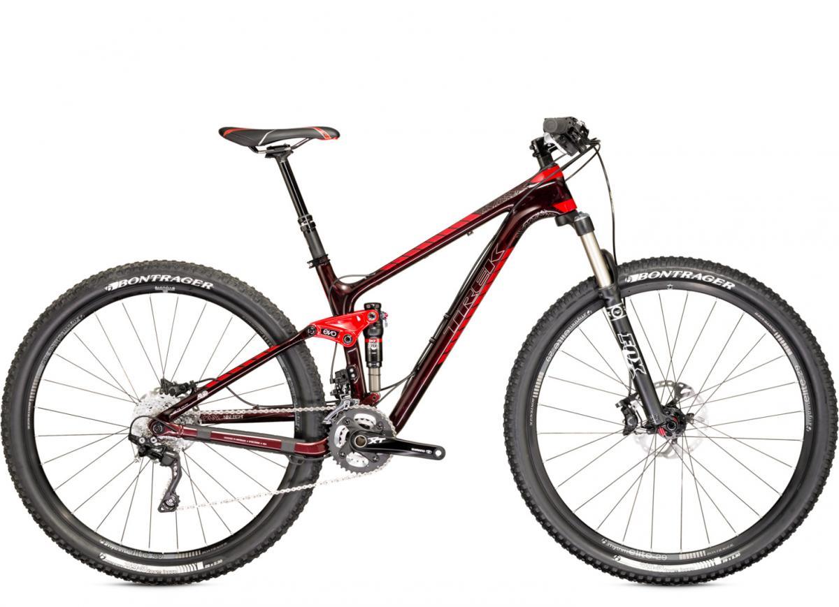 Trek Fuel EX: A red and black mountain bike with a lightweight frame, front suspension, and wide tires, positioned against a white background. The bike features disc brakes, a visible gear system, and a comfortable saddle, designed for off-road cycling.