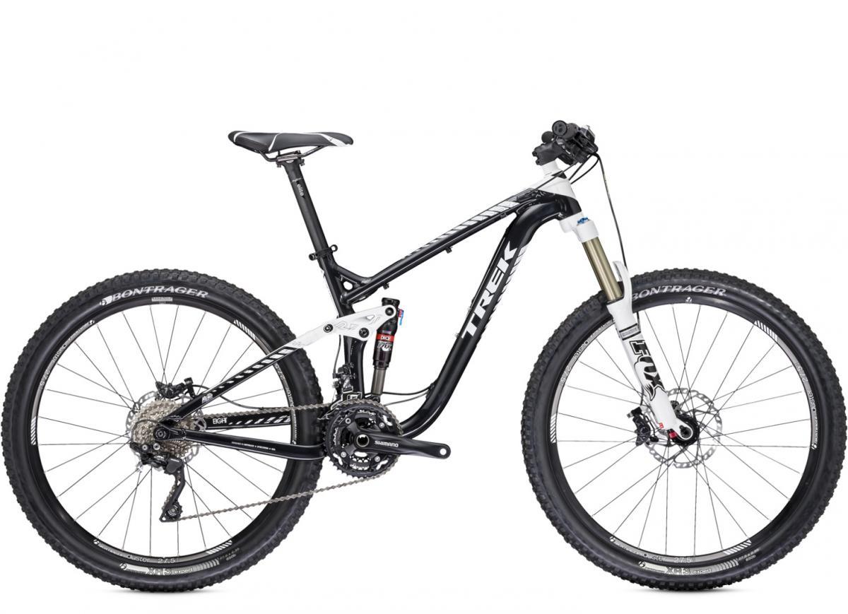 Trek Remedy 8 27.5/650b: Black and white mountain bike with a sleek design, featuring a suspension fork, disc brakes, and wide tires, positioned upright against a neutral background.