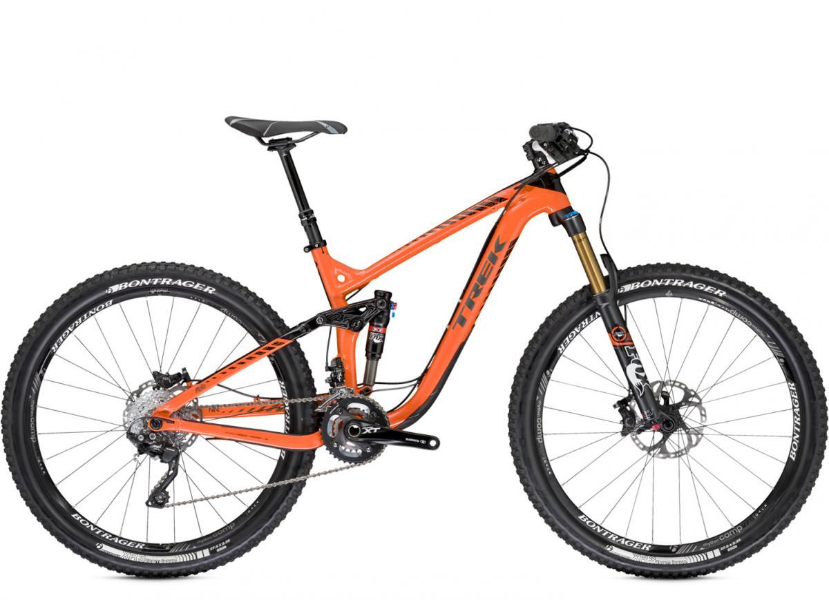 Trek Remedy 9 27.5/650b: Mountain bike with an orange frame, featuring a suspension system and high-performance tires. The bike is equipped with Shimano XT components and Bontrager wheels, designed for rugged terrain and off-road cycling.