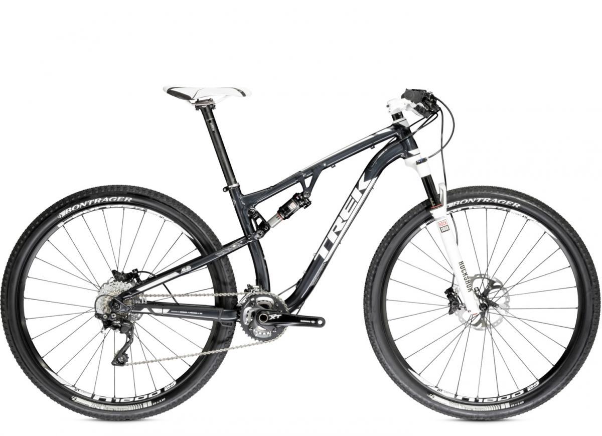 Trek Superfly FS 9: Mountain bike with a sleek black frame, white accents, and high-quality components, showcasing a front suspension fork, disc brakes, and Bontrager tires.