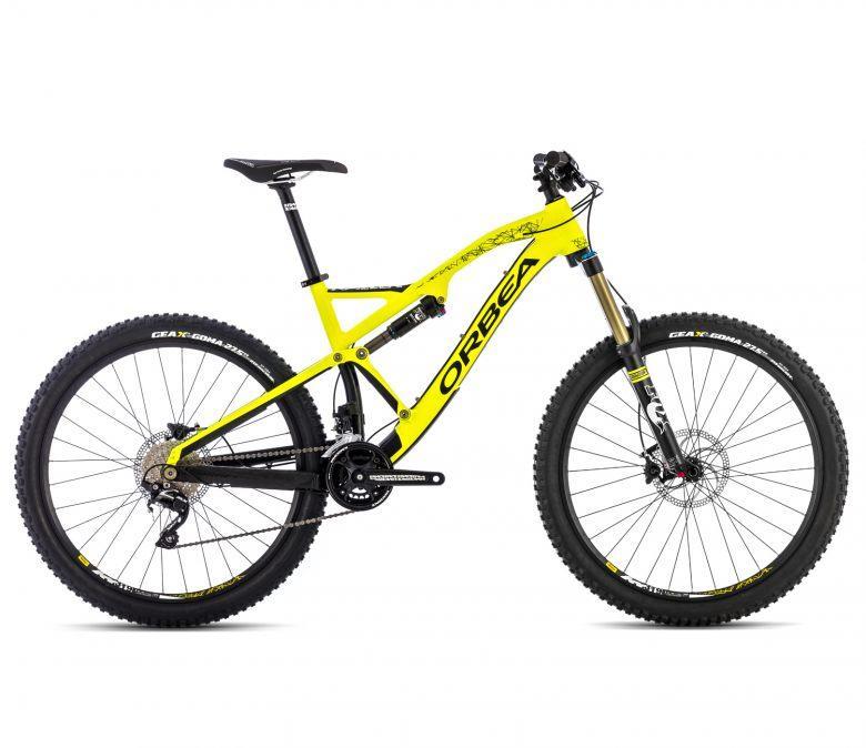 Orbea Rallon X-30: A bright yellow mountain bike with a sleek frame, featuring front suspension, thick knobby tires, and disc brakes. The bike is branded with the name "ORBEA" and displays modern design elements suitable for off-road cycling.